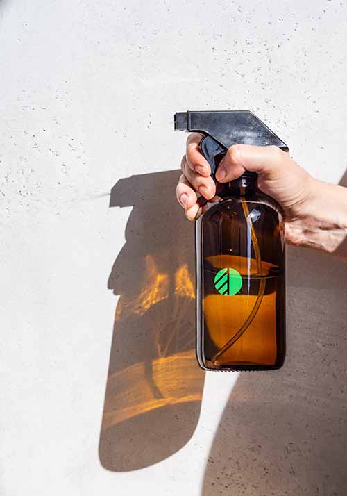 Brown spray bottle with green OBEX logo